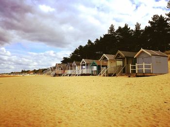 Houses on beach against sky