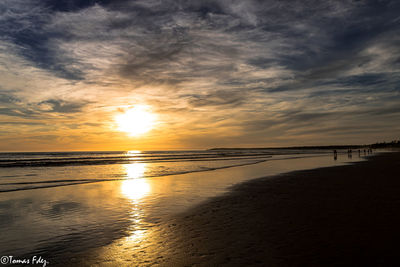 Scenic view of beach against sky during sunset