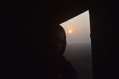 Close-up of silhouette woman against sky during sunset