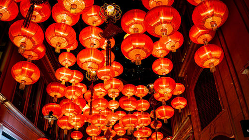 Low angle view of illuminated lanterns hanging at night