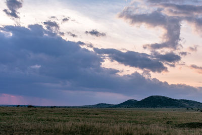 Scenic view of field against sky during sunset
