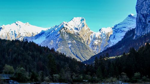 Scenic view of snowcapped mountains against clear sky