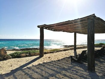 Gazebo on beach against clear sky