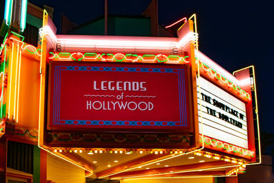 Low angle view of illuminated sign at night