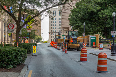 Road amidst trees and buildings in city