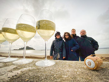 Portrait of people standing by glass