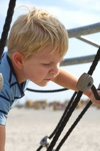 Rear view of boy holding umbrella