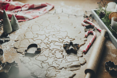 Merry christmas, happy new year. gingerbread cookies cooking, rolled dough on table, cutting forms