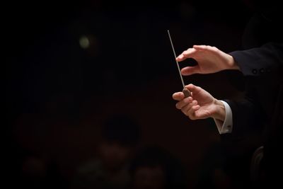 Cropped image of conductor in orchestra