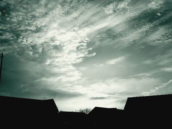 Low angle view of silhouette trees against sky