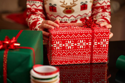 Midsection of woman holding christmas presents