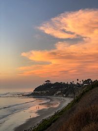 Scenic view of beach against sky during sunset