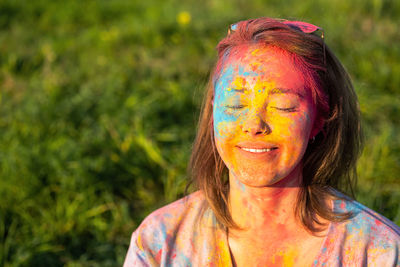 Woman covered holi powder in park. holi colours festival.