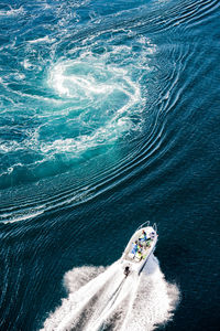 High angle view of people traveling in yacht on sea