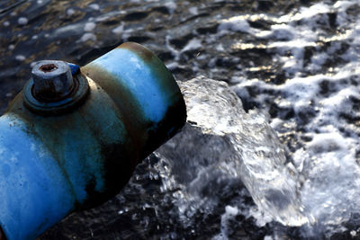 Close-up of water pipe on rock