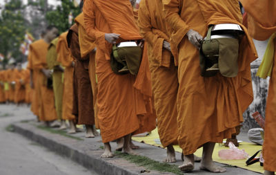 Monks standing in line on walkway