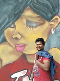 Portrait of smiling young man standing outdoors