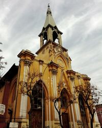 Low angle view of bell tower against sky