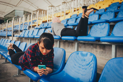 Man using mobile phone while sitting on seat