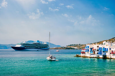 Little venice houses in chora mykonos town with yacht and cruise ship. mykonos island, greece