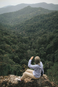 Rear view of woman looking at mountain view