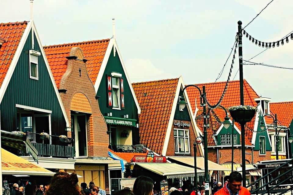 architecture, built structure, building exterior, low angle view, roof, sky, residential building, city, residential structure, day, hanging, house, outdoors, building, railing, balcony, market, roof tile, city life, retail