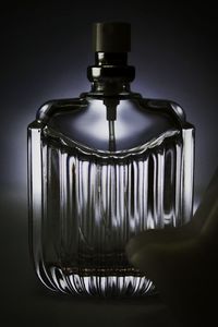 Close-up of empty glass bottle against black background