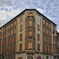 Low angle view of building against cloudy sky