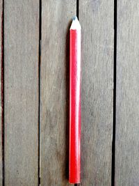 Close-up of red wooden plank on table