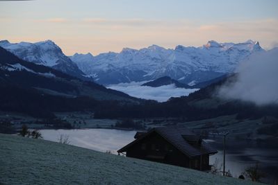 Scenic view of snowcapped mountains against sky during winter