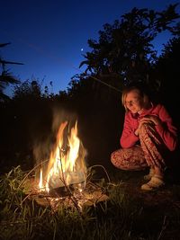 Full length of woman with fire at night