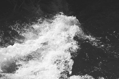 High angle view of waves splashing in sea