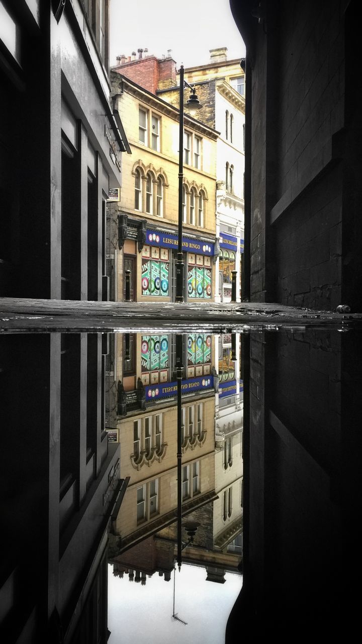 REFLECTION OF BUILDINGS ON GLASS WINDOW