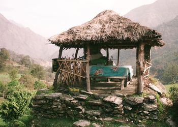 Wooden house roof on mountain against sky