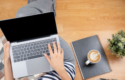 Directly above view of man using laptop on table