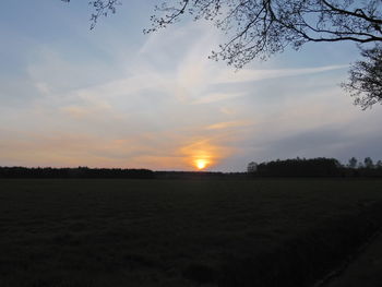 Scenic view of landscape against sky at sunset