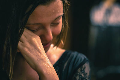 Close-up of wet smiling girl looking down