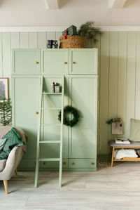 Cozy christmas bedroom interior with mint wardrobe and sofa. new year's home decor