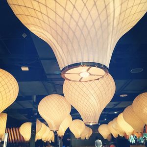 Low angle view of illuminated chandelier hanging from ceiling