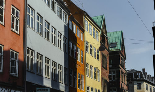 Low angle view of buildings against clear blue sky