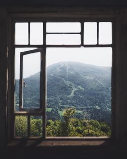 Scenic view of mountains seen through window