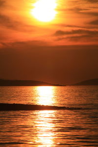 Scenic view of sea against orange sky