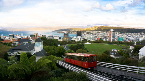 View of cityscape against cloudy sky