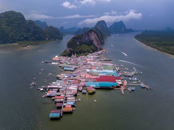 High angle view of boats in sea against mountains