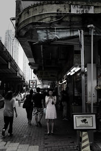 People walking on footpath in city