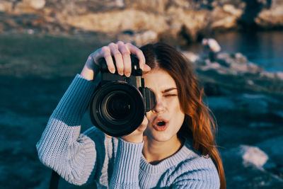 Portrait of woman photographing