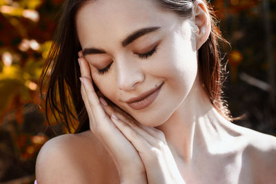 Beauty portrait of a young woman on a natural background