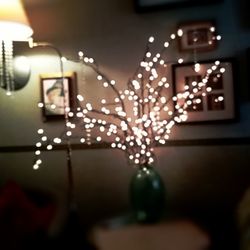 Close-up of illuminated lamp on table at home