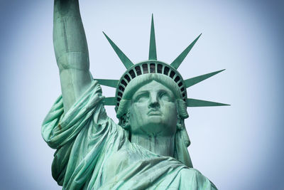 Low angle view of statue of liberty against sky