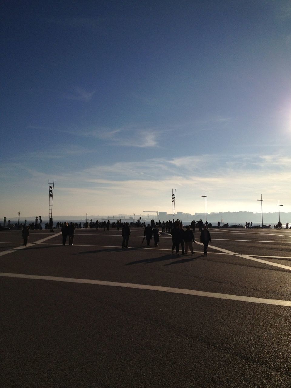 sky, road, the way forward, transportation, road marking, street, cloud - sky, diminishing perspective, street light, vanishing point, cloud, empty, silhouette, outdoors, asphalt, cloudy, incidental people, day, blue, in a row